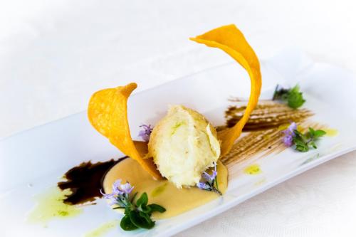 a white plate with a piece of ice cream and fruit at Tenuta Del Gallo in Amelia