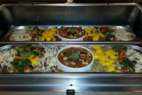 three trays of different types of food in an oven at Hotel Dream Of Side in Side