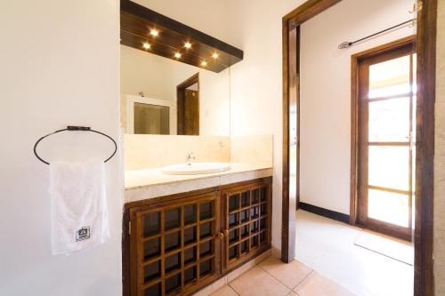 a bathroom with a sink and a mirror at Ameg Lodge Kilimanjaro in Moshi