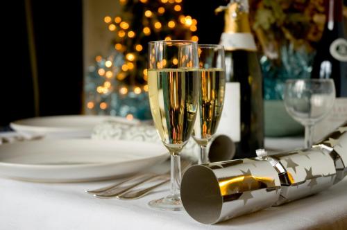 a table with two champagne glasses and a bottle of wine at Guildford Manor Hotel & Spa in Guildford