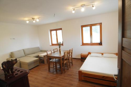 a living room with a couch and a table at Chata Wostry in Bílá