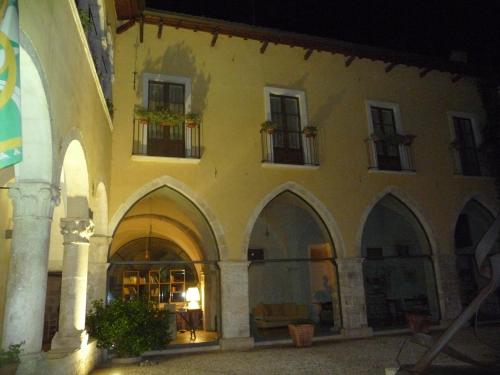 a large building with arches and windows at night at Grancia dei Celestini in Sulmona