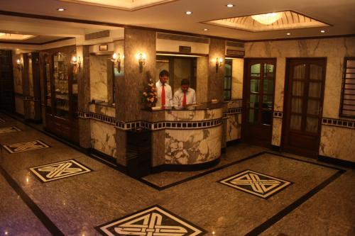 two people standing in a bathroom in a hotel lobby at Hotel Karl Residency in Mumbai