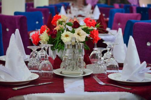 a table with red and white flowers on top of it at Almounia Hotel & Spa in Taroudant
