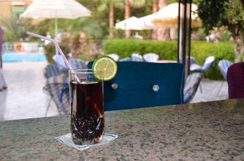 a drink on a table with a slice of lime at Almounia Hotel & Spa in Taroudant