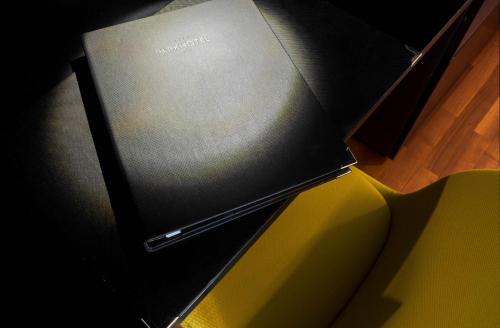 a laptop computer sitting on top of a yellow box at Park Hotel Zug in Zug