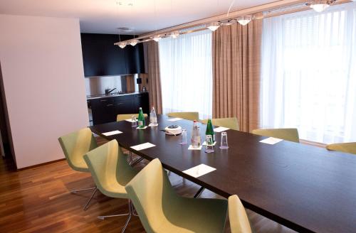 a dining room with a table and chairs at Parkhotel Zug in Zug