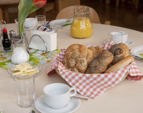 a basket of bread and pastries on a table at Luise Wehrenfennig & Haus EvA in Bad Goisern