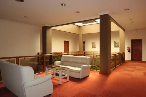 a living room with two chairs and a table at Hotel Contriz in Póvoa de Varzim