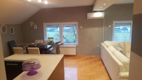 a living room with a white couch and a table at Apartman Armin in Sarajevo
