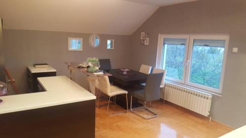 a kitchen with a table and chairs in a room at Apartman Armin in Sarajevo