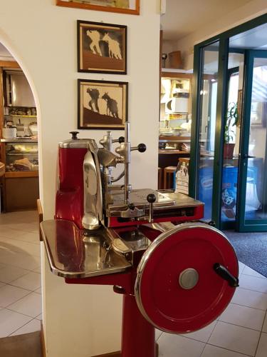 a red machine sitting on a counter in a room at I Personaggi in Udine