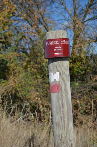 a wooden pole with a sign on top of it at Casa Emma in Villamarciel