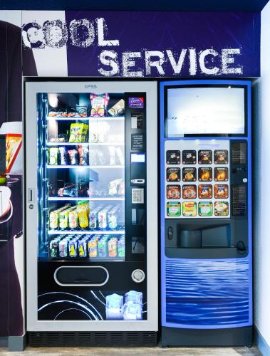 a large refrigerator with its door open with food inside at Ibis Budget Salzburg Airport - Self-Check-In in Salzburg