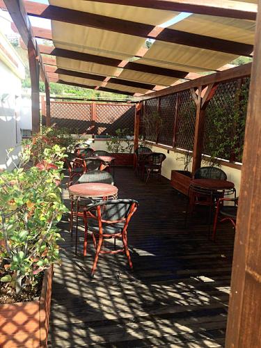 a patio with tables and chairs on a deck at Culture Residence Consalvo Otto in Naples