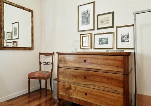 a bedroom with a dresser and a chair and a mirror at Bed and Breakfast For You in Bussolengo