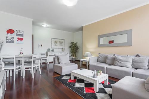 a living room with a couch and a table at Achada I by An Island Apart in Funchal