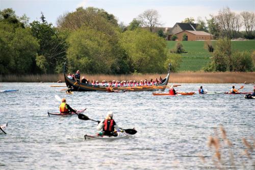 a group of people in boats on a river at Rødkærgård Bed & Breakfast in Kerteminde