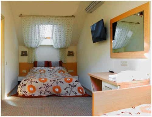 a bedroom with a bed and a mirror at Hotel MAMAN in Odesa