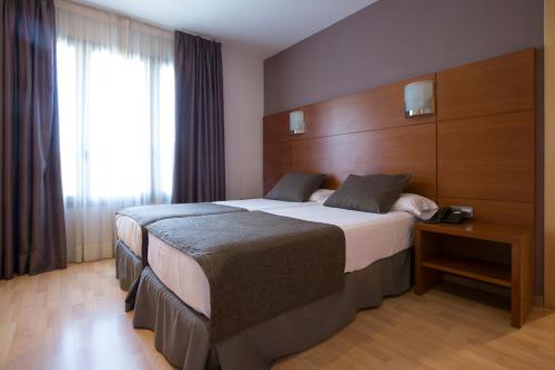 Ένα ή περισσότερα κρεβάτια σε δωμάτιο στο Hotel Via Augusta