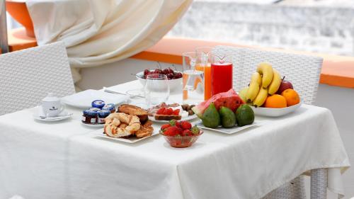 a table with fruits and vegetables on a white table cloth at Monteforte Resort in Ugento