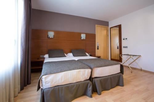 Ένα ή περισσότερα κρεβάτια σε δωμάτιο στο Hotel Via Augusta