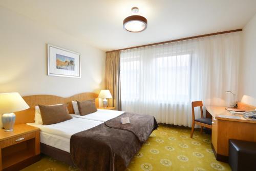 a hotel room with a bed and a desk at Hotel Agit Congress&Spa in Lublin