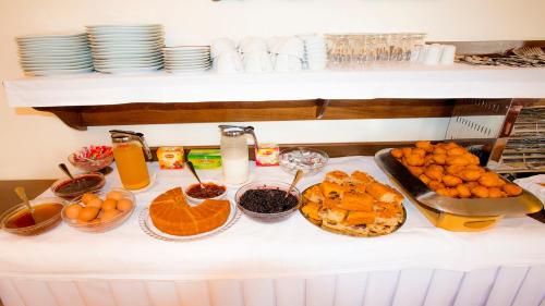 a table topped with lots of food on top at Mirtillo Apartments in Kissós