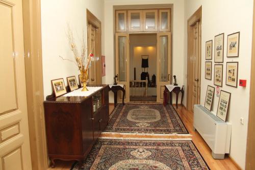 a hallway with a room with a rug and a door at Hotel Panellinion in Tríkala