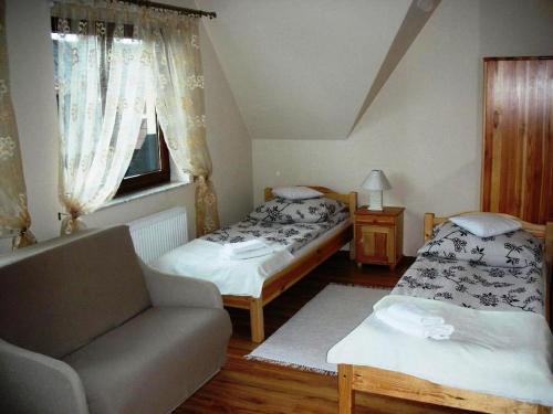 Łóżko lub łóżka w pokoju w obiekcie Apartamenty U Lutnika Centrum Zakopane