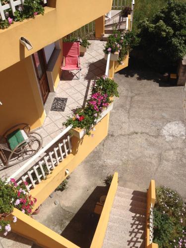 an overhead view of a balcony with flowers and a chair at Stella Del Sud in Cuglieri
