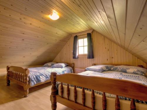 a bedroom with two beds in a log cabin at Hiška vogar in Bohinj