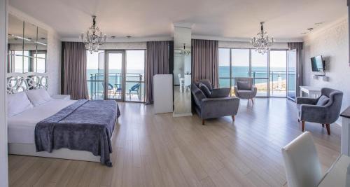 a bedroom with a bed and a living room at Tina's Apartments with Panoramic Sea view in Batumi