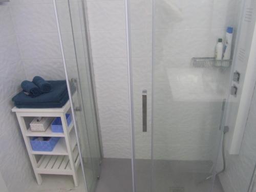 a shower with a glass door in a bathroom at Los Cristianos studio, modern, spacious, pool,WiFi in Arona