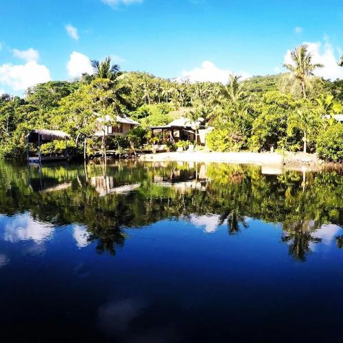 a large body of water with houses and trees at Salt Lake Lodge in Savusavu