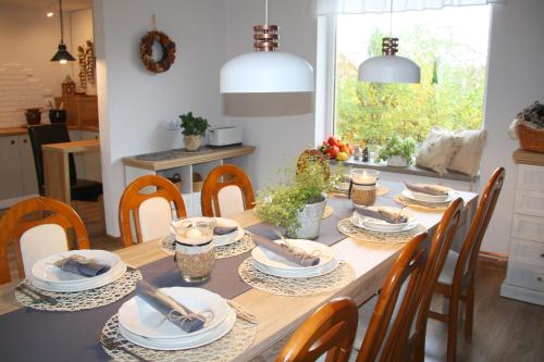 a dining room table with chairs and a dining room table at Młynarzowa Chata in Lesko
