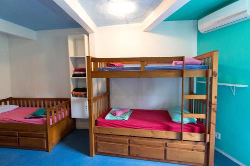 two bunk beds in a room with blue ceilings at Natural Do Rio Guesthouse in Rio de Janeiro