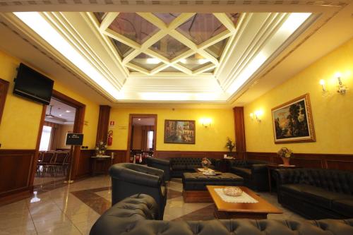a living room with couches and a coffered ceiling at Tricolore Hotel in Gaida