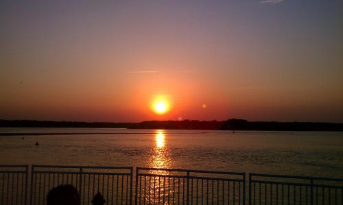a sunset over a body of water at Tandem Bike Inn in Belmar