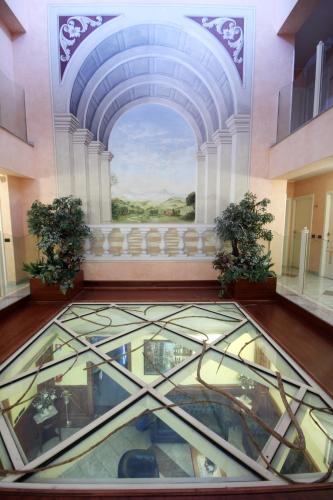 a glass floor in a building with a glass ceiling at Tricolore Hotel in Gaida