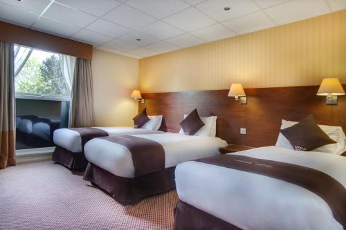 Ein Bett oder Betten in einem Zimmer der Unterkunft Apollo Hotel