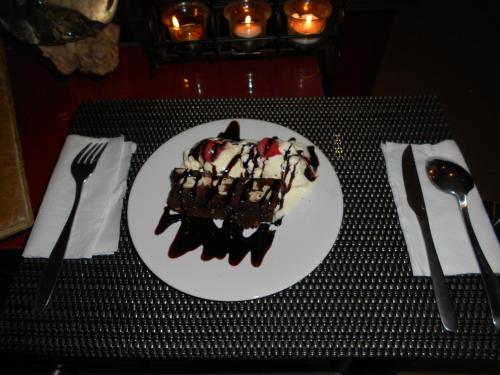 a white plate with a piece of cake on a table at Silver Fern Beach Retreat in Sekotong