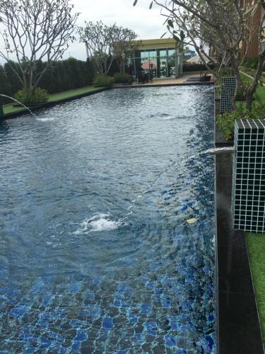 a pool of water with a water hose at Stay in Style, Stay On The Cloud RS504 in Chiang Mai