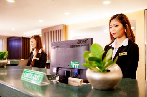 two women standing at a desk in an office at The Charter House in Manila