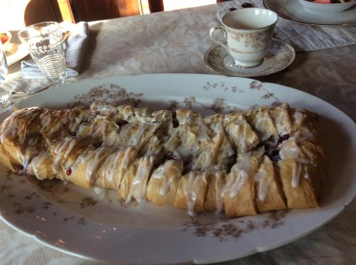 a white plate with a piece of food on a table at Lehmann House Bed & Breakfast in Saint Louis