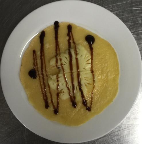 a white plate with a dessert with chocolate sauce at Goda Boutique Hotel in Hoi An