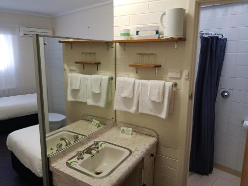 a bathroom with a sink and a mirror at Morphett Arms Hotel in Adelaide