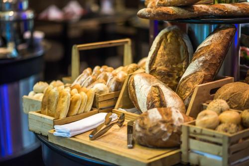 a display of bread and pastries on a table at The Landmark Bangkok in Bangkok