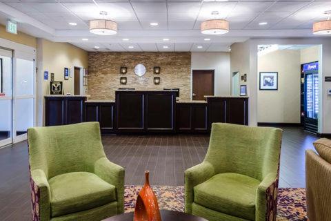 a waiting room with two chairs and a table at Comfort Inn & Suites Dothan East in Dothan