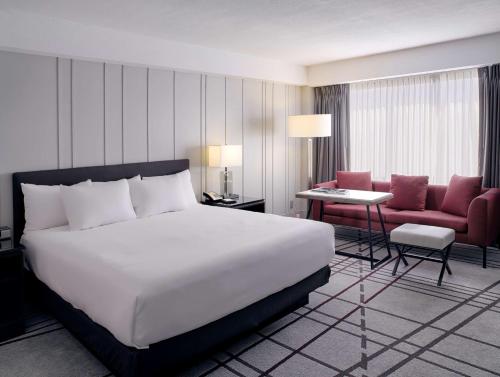 a hotel room with a bed and a chair at Hyatt Regency Louisville in Louisville